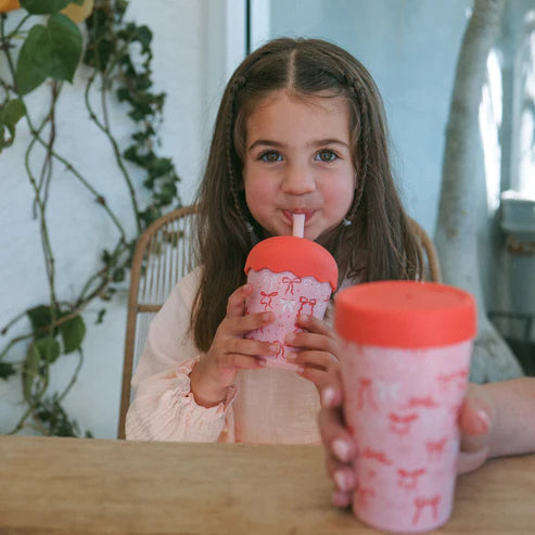 girl drinking from bow design smoothie cup