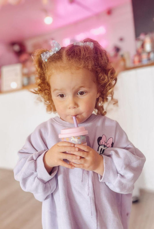 Unicorn babychino cup with lid and straw in coffee shop