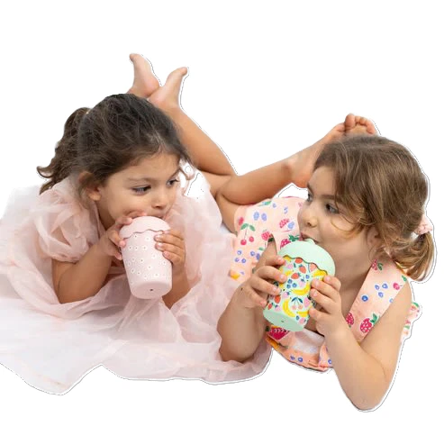two girls drinking from smoothie cups with straws