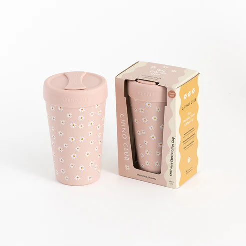 Pink floral-patterned coffee cup with packaging on a white background