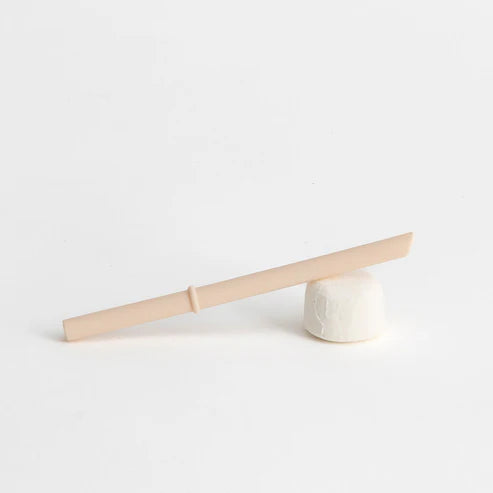 beige straw with stopper balancing on a marshmallow