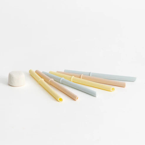 Set of pastel-colored straws on a white background