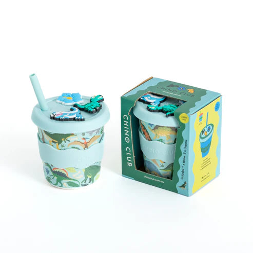 Children's tumbler with dinosaur design and matching packaging on a white background