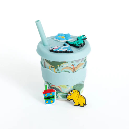 Light blue Chino Charm cup with dinosaur design, straw, and accessories on a white background