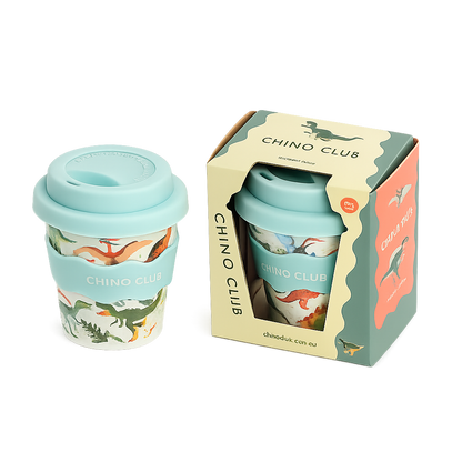 CHINO CLUB Dinosaur 4oz reusable babychino cup with matching gift box, featuring a fun dinosaur print, food-safe silicone lid and sleeve. A perfect gift for toddlers and young children.
