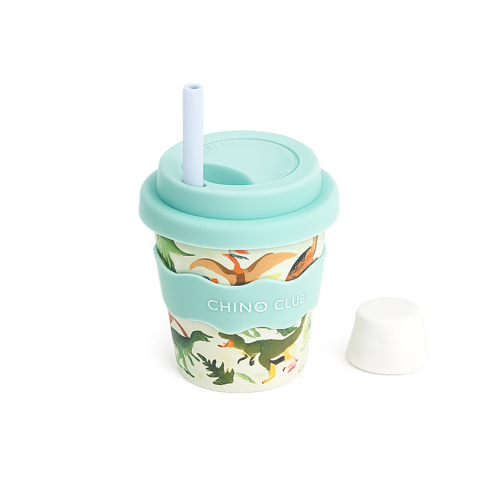 CHINO CLUB Dinosaur 4oz reusable babychino cup featuring a playful dinosaur print, food-safe silicone lid and sleeve, reusable stopper straw and matching straw cap. Perfect for babychinos, milk and little hands