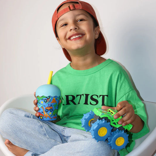 child holding 200ml bpa free smoothie cup with monster truck smiling