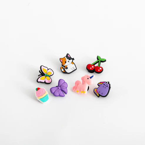 Set of colorful girls cartoon-style pins on a white background