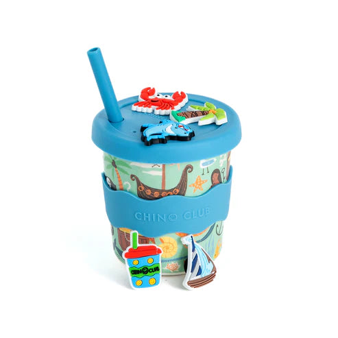 Colorful chino charm cup with a blue lid and straw, featuring a crab, car, and sailboat design, on a white background. Pirate theme