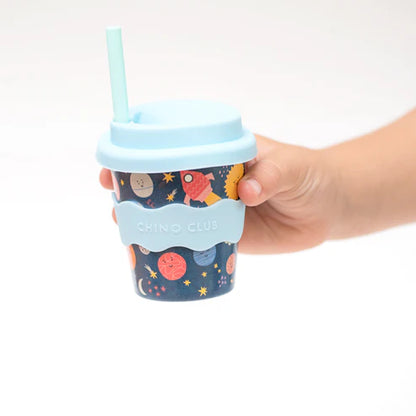 holding babychino cup space theme