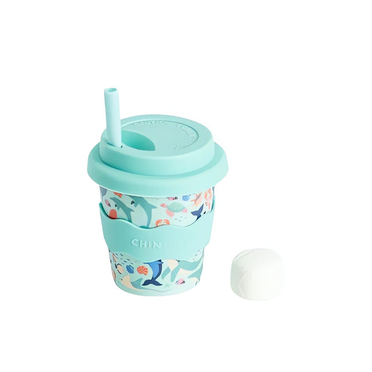 Reusable cup with sea animal design and turquoise lid on a white background with straw