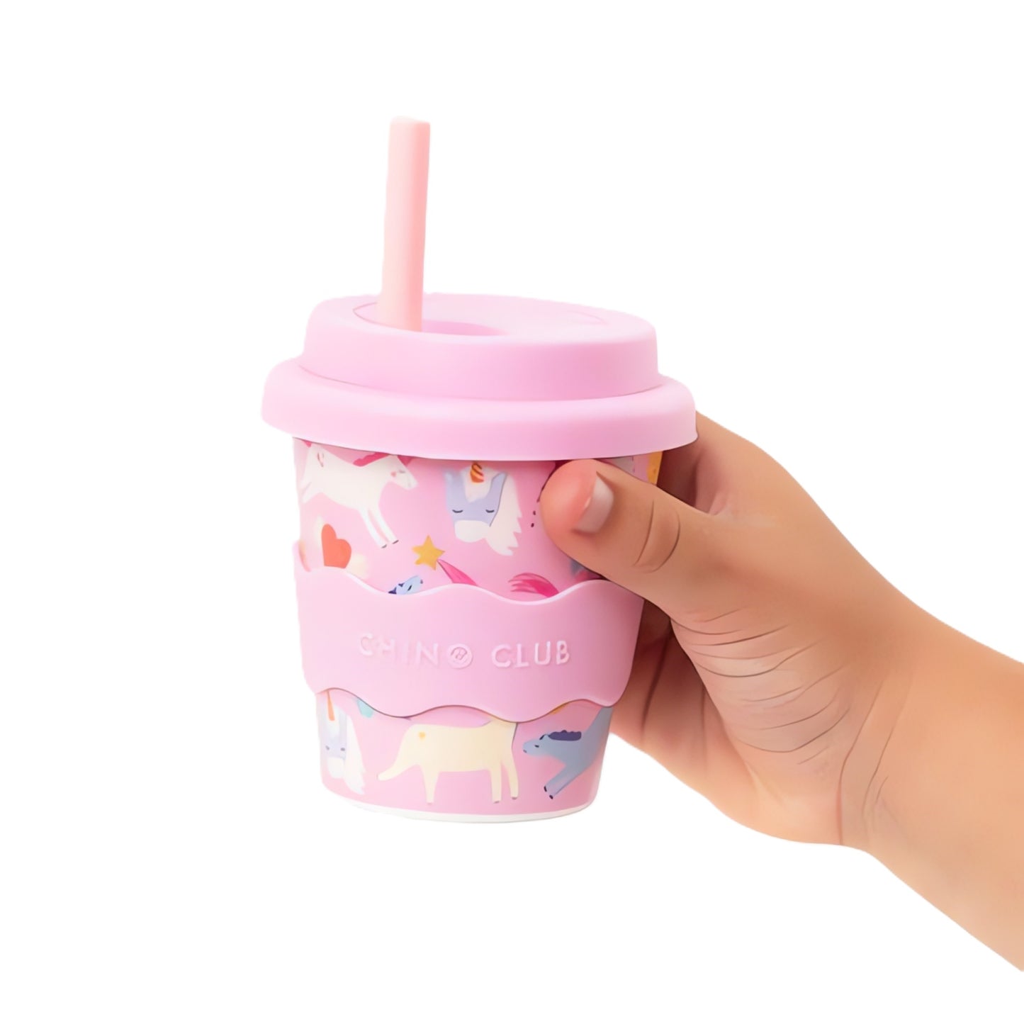 Hand holding a pink unicorn chino club cup with unicorn design on a white background