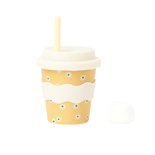 Yellow cup with white lid and straw on a white background
